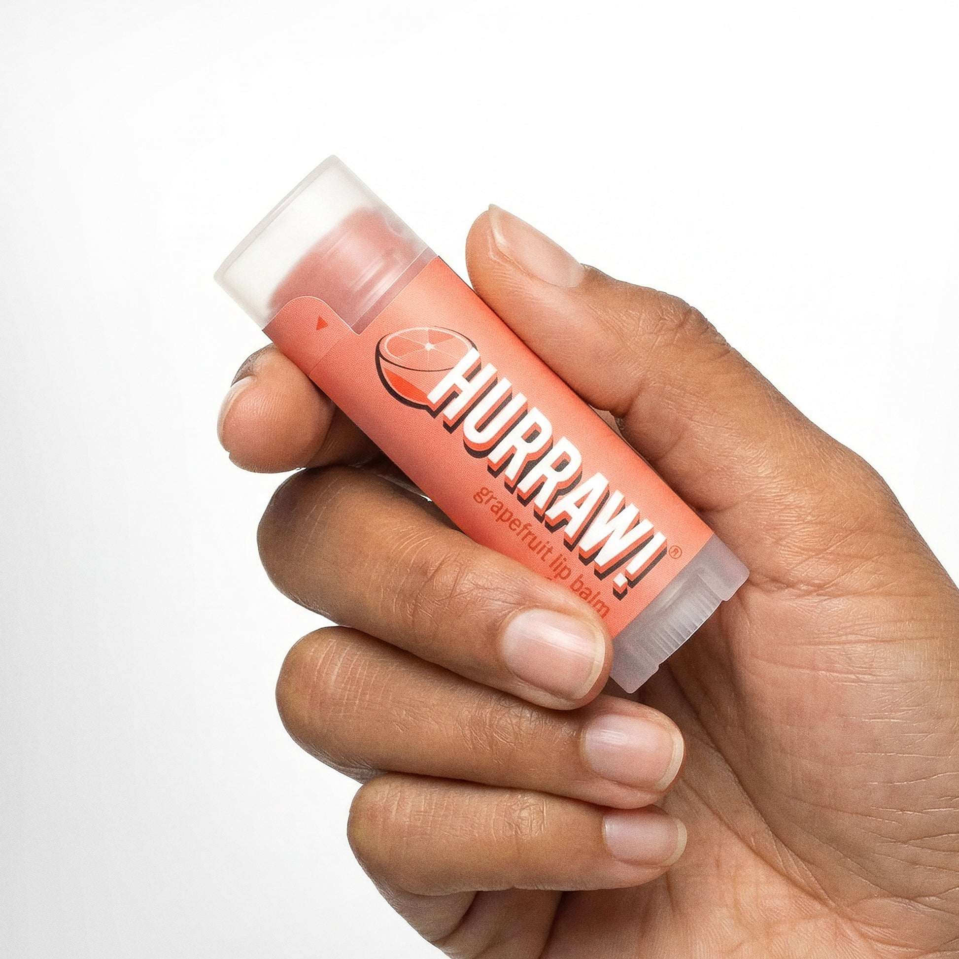 Hurraw grapefruit lippenbalsem productfoto op lichte achtergrond