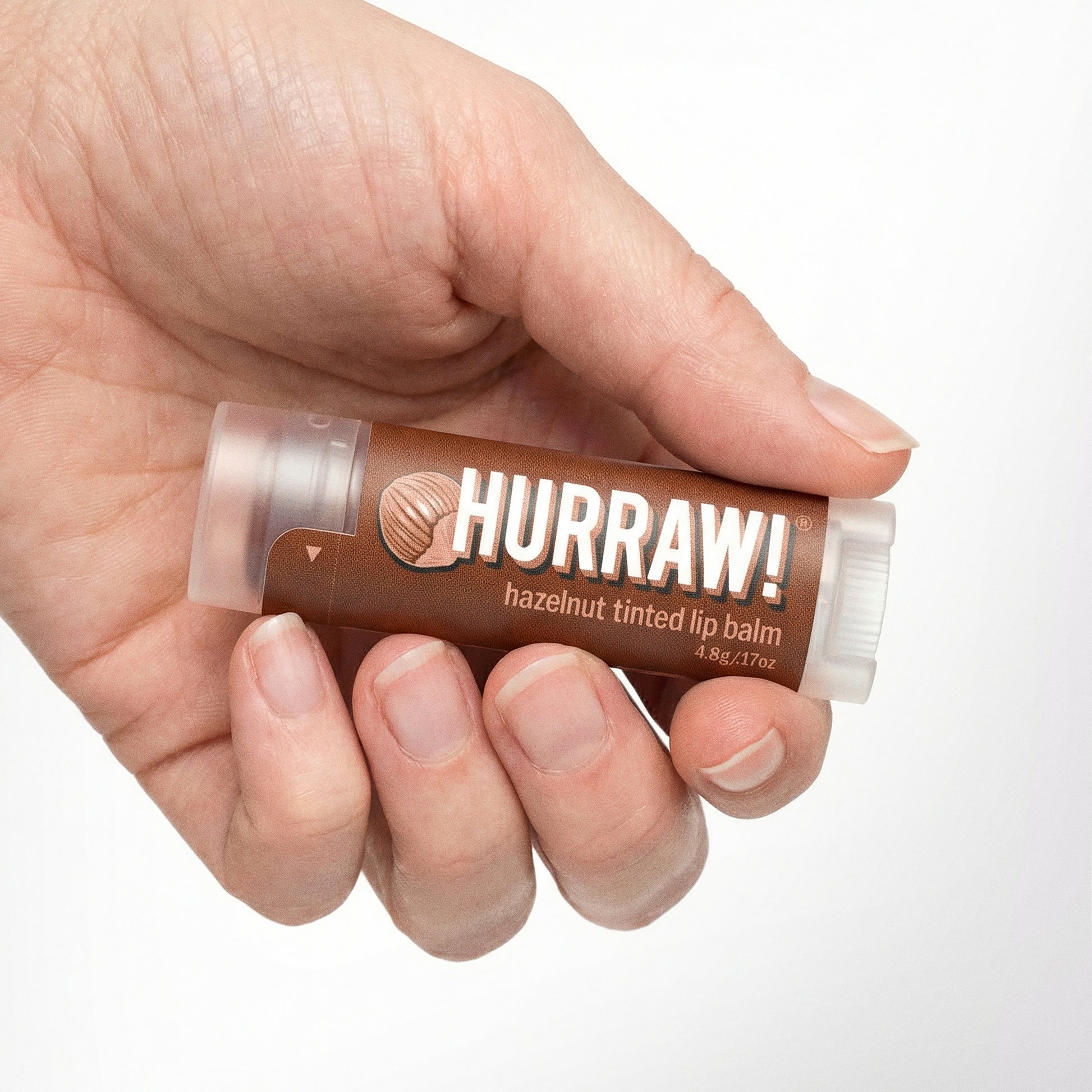 Hurraw hazelnoot getinte lippenbalsem in de hand